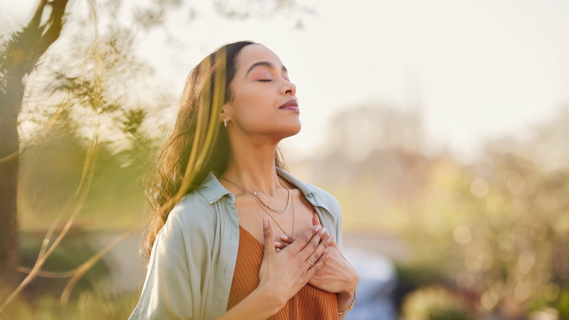 woman meditating outside giving herself peace