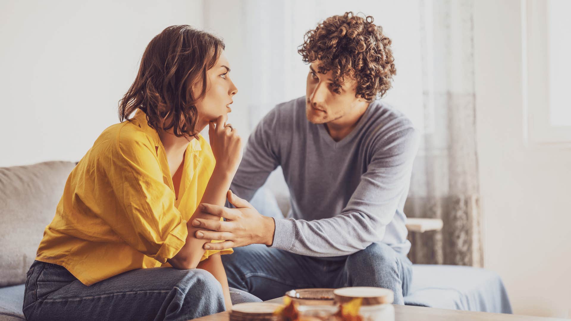 woman talking to emotionally normal man on couch