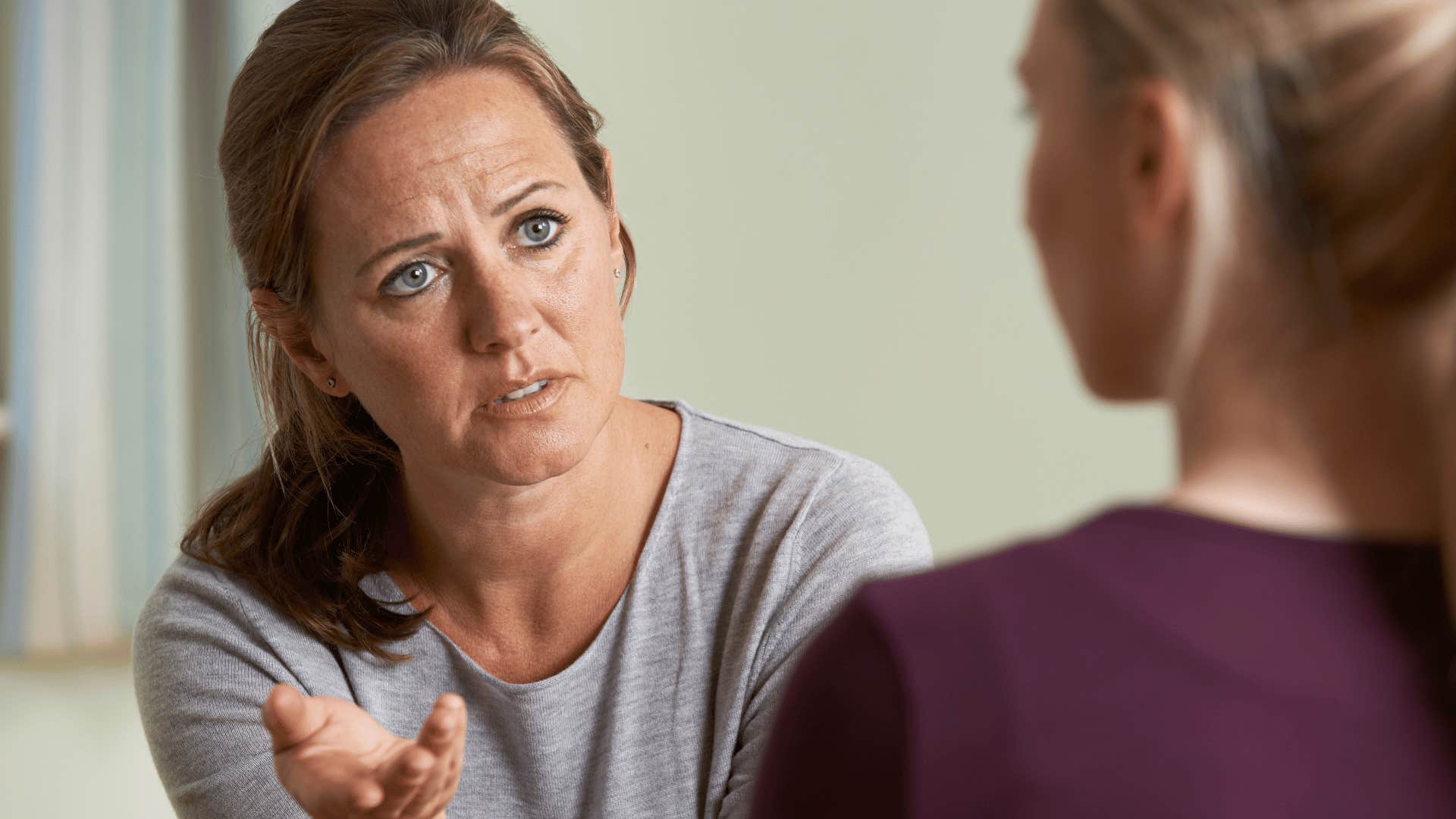 upset mother talking to daughter