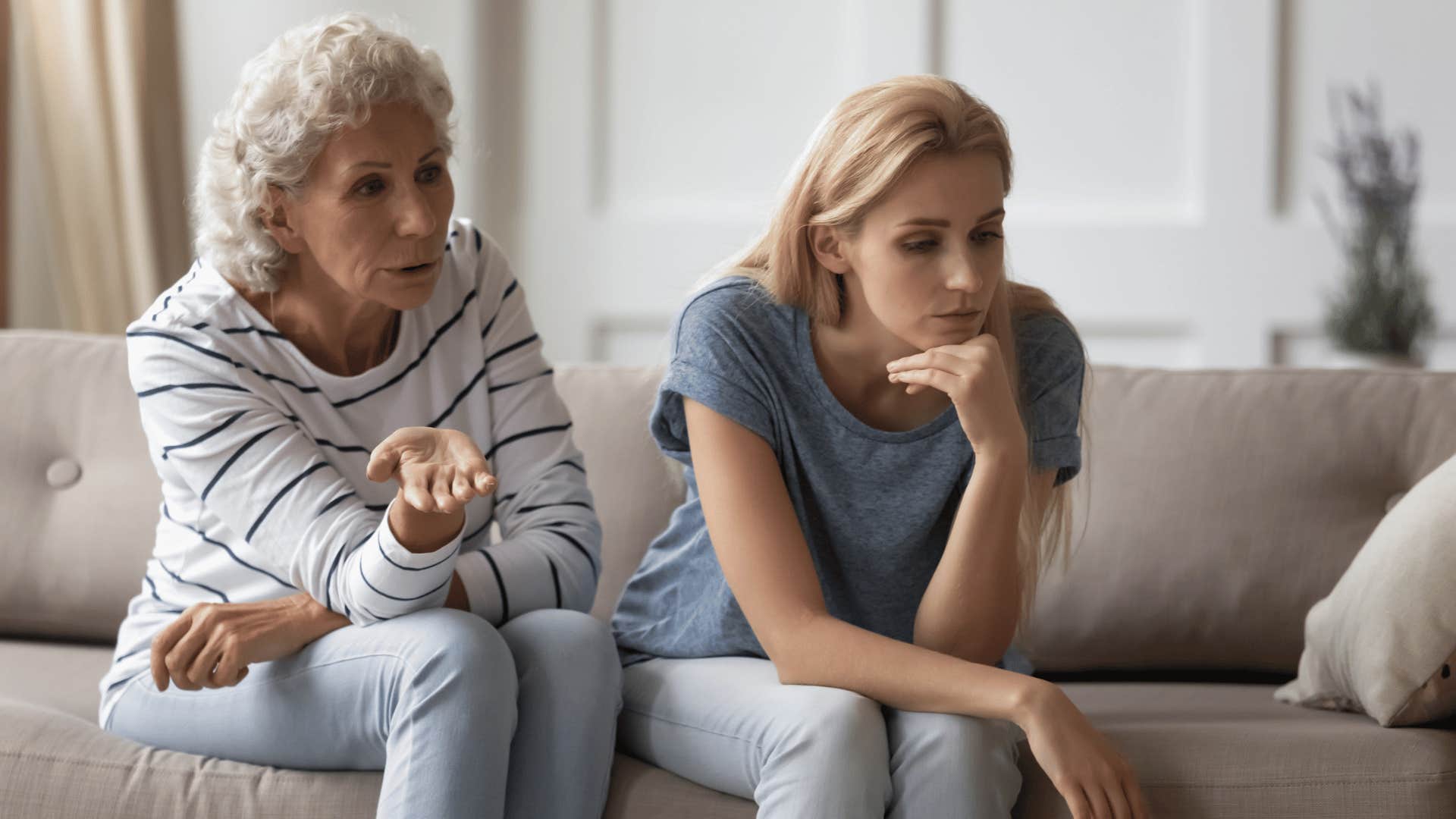 older woman yelling at daughter on couch