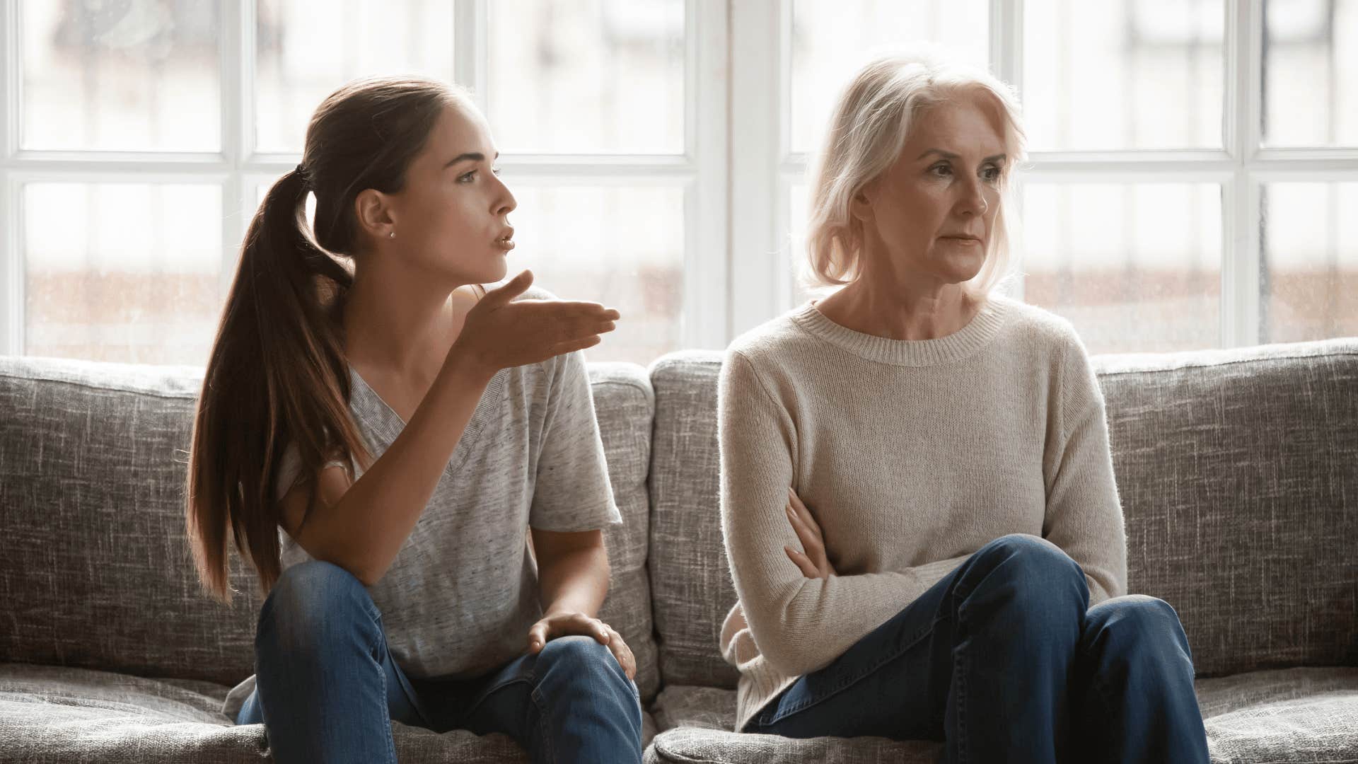 woman arguing with mother on couch