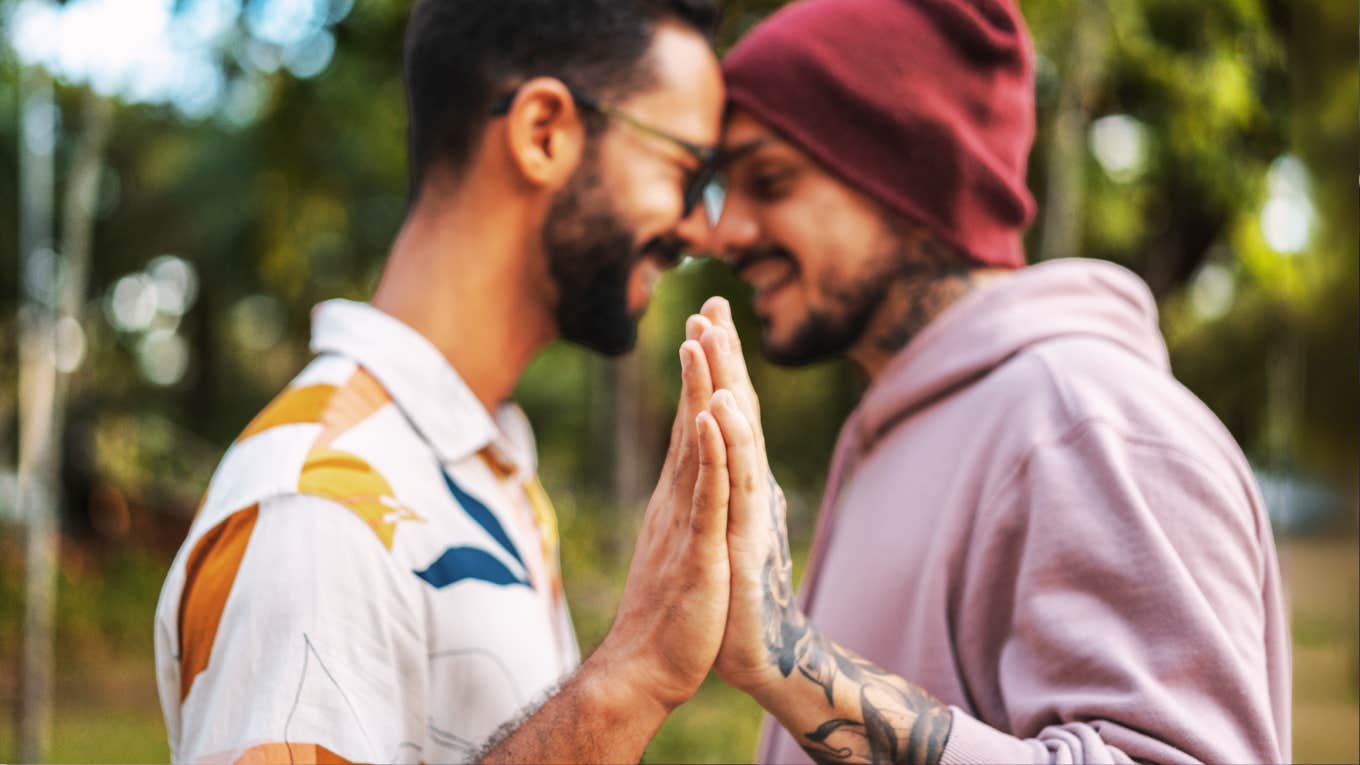 Hidden Clues in Your Hands That Expose Just How Strong Your Relationship Is, According To Expert Palm Reader Couple with hands together exposing how strong their relationship is.