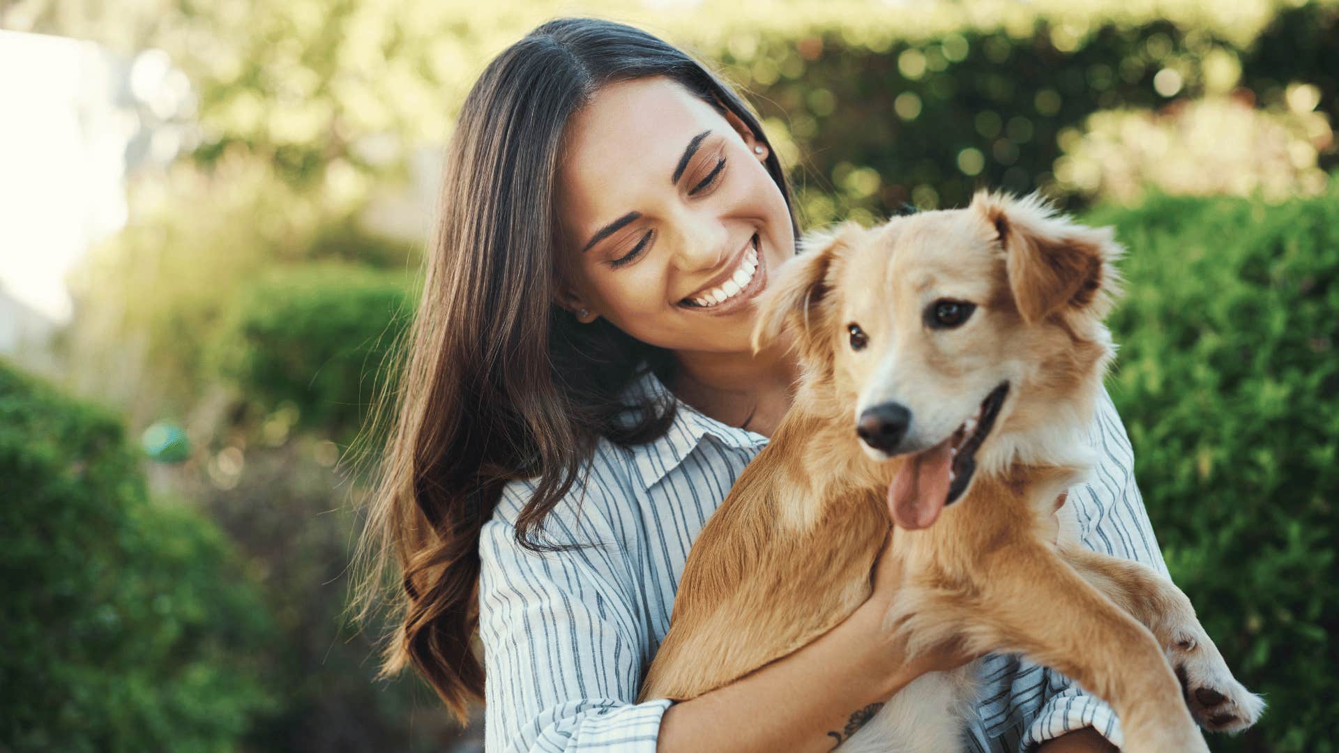 woman giving her dog attention