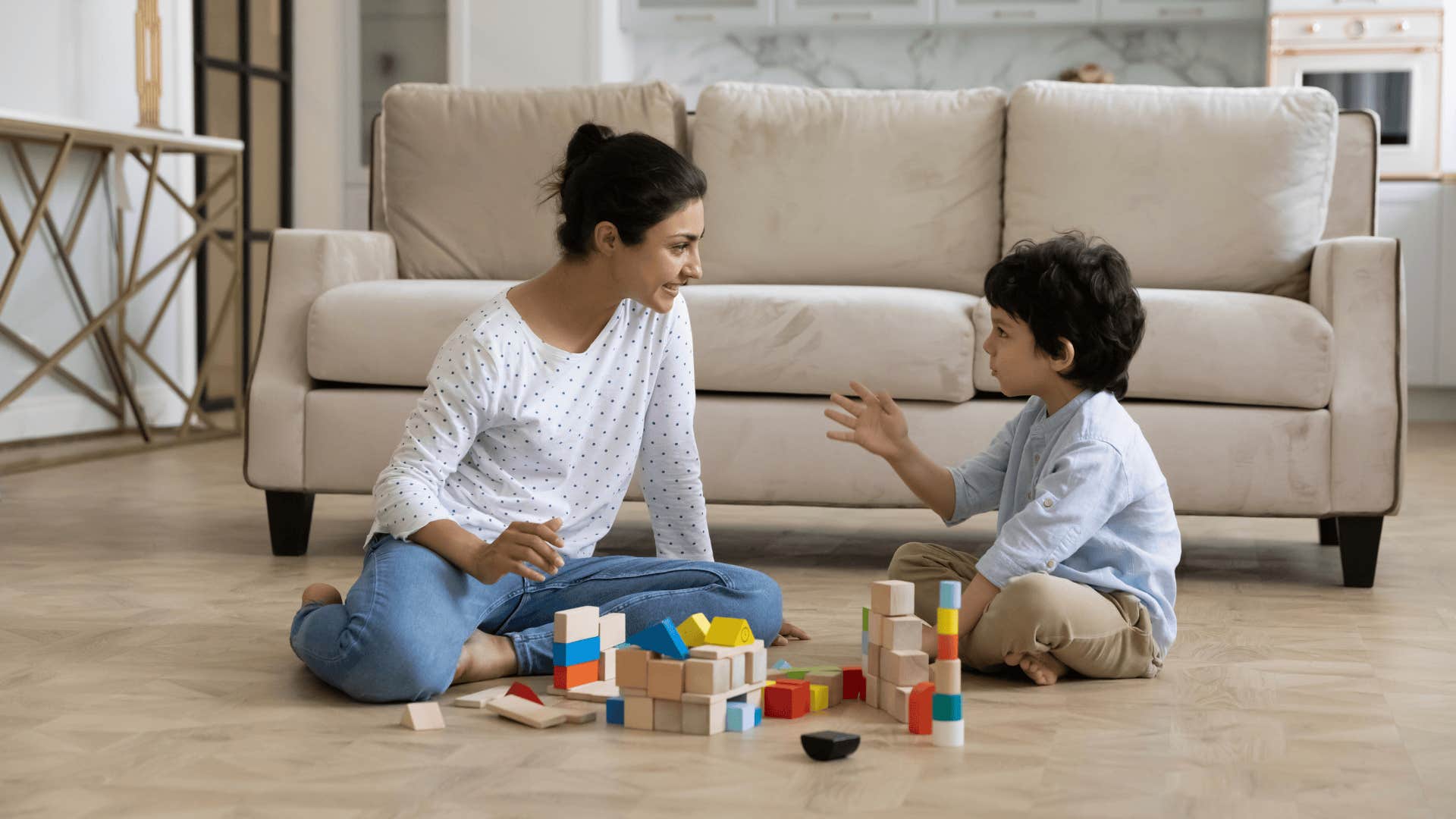 mother playing with toys as incredible side effect of being a parent