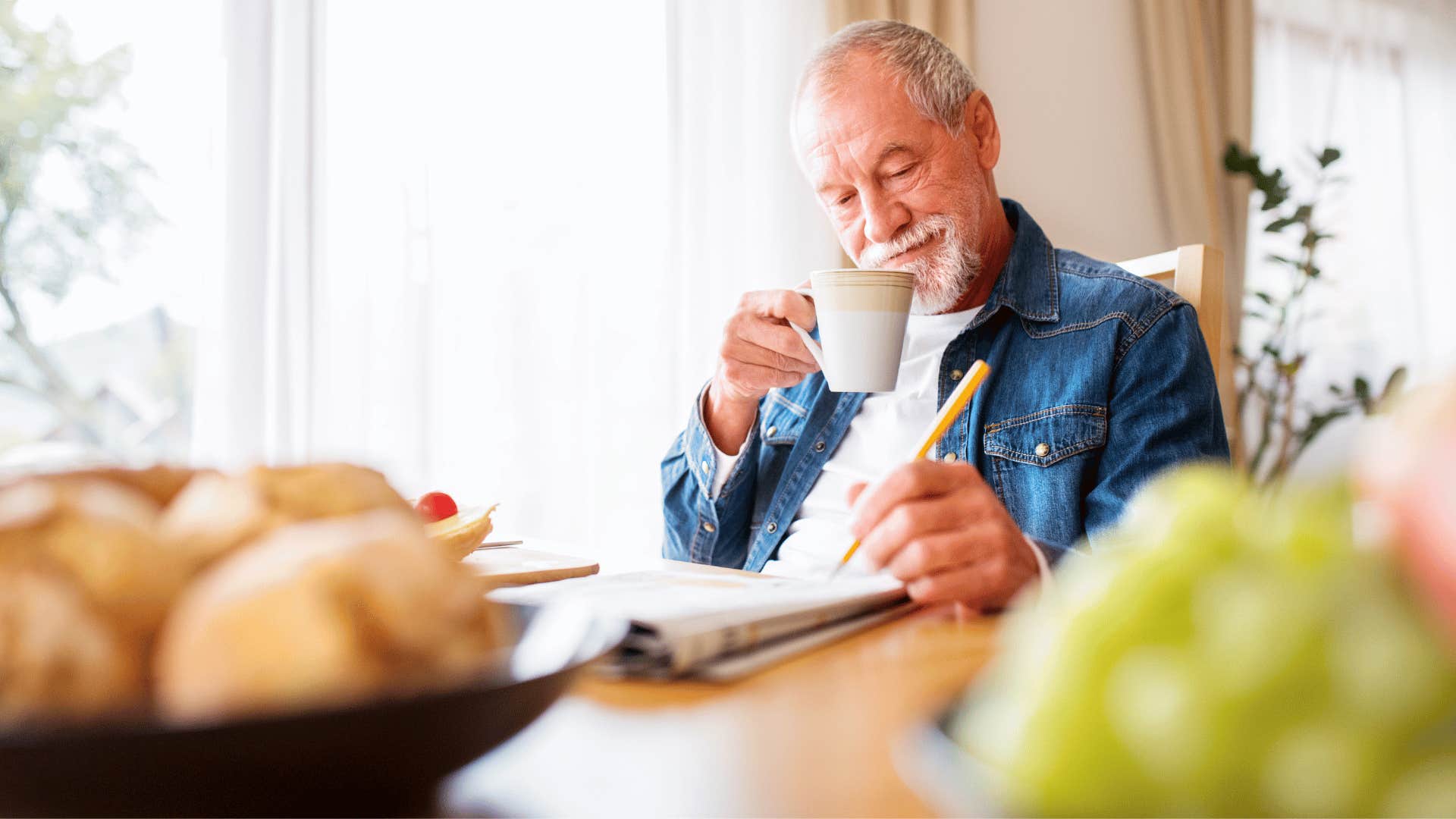 happy man doing crossword puzzle