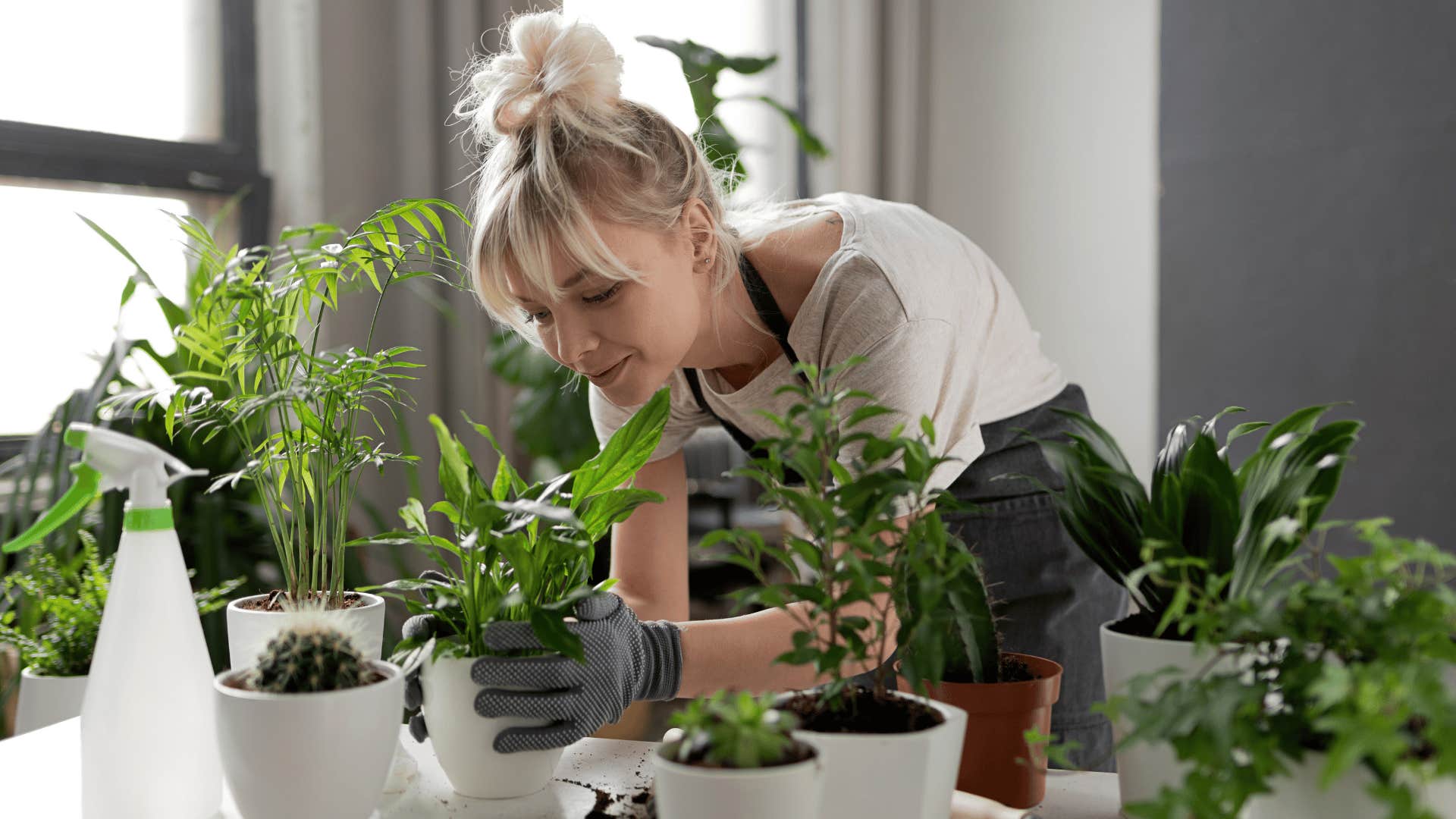 woman tending to indoor garden