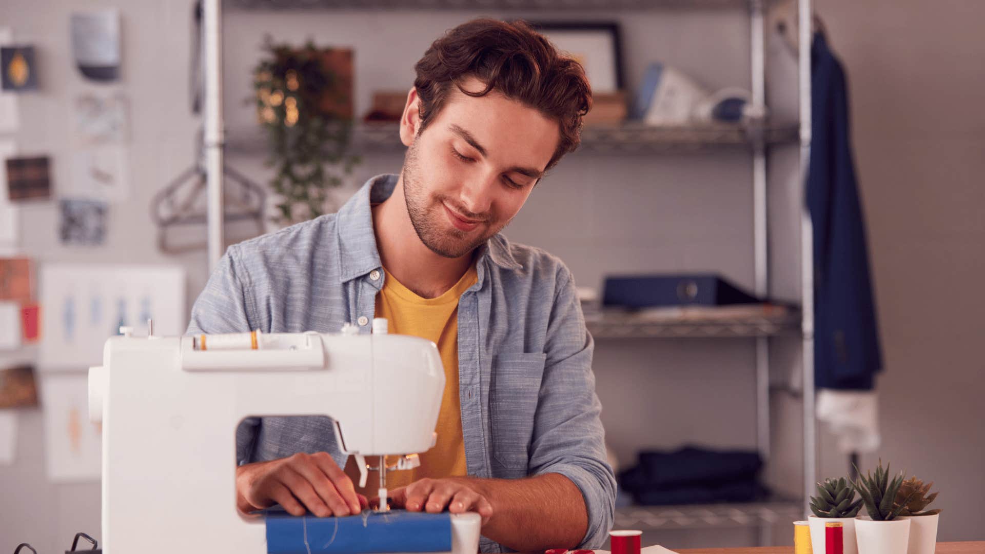 smiling man sewing fabric