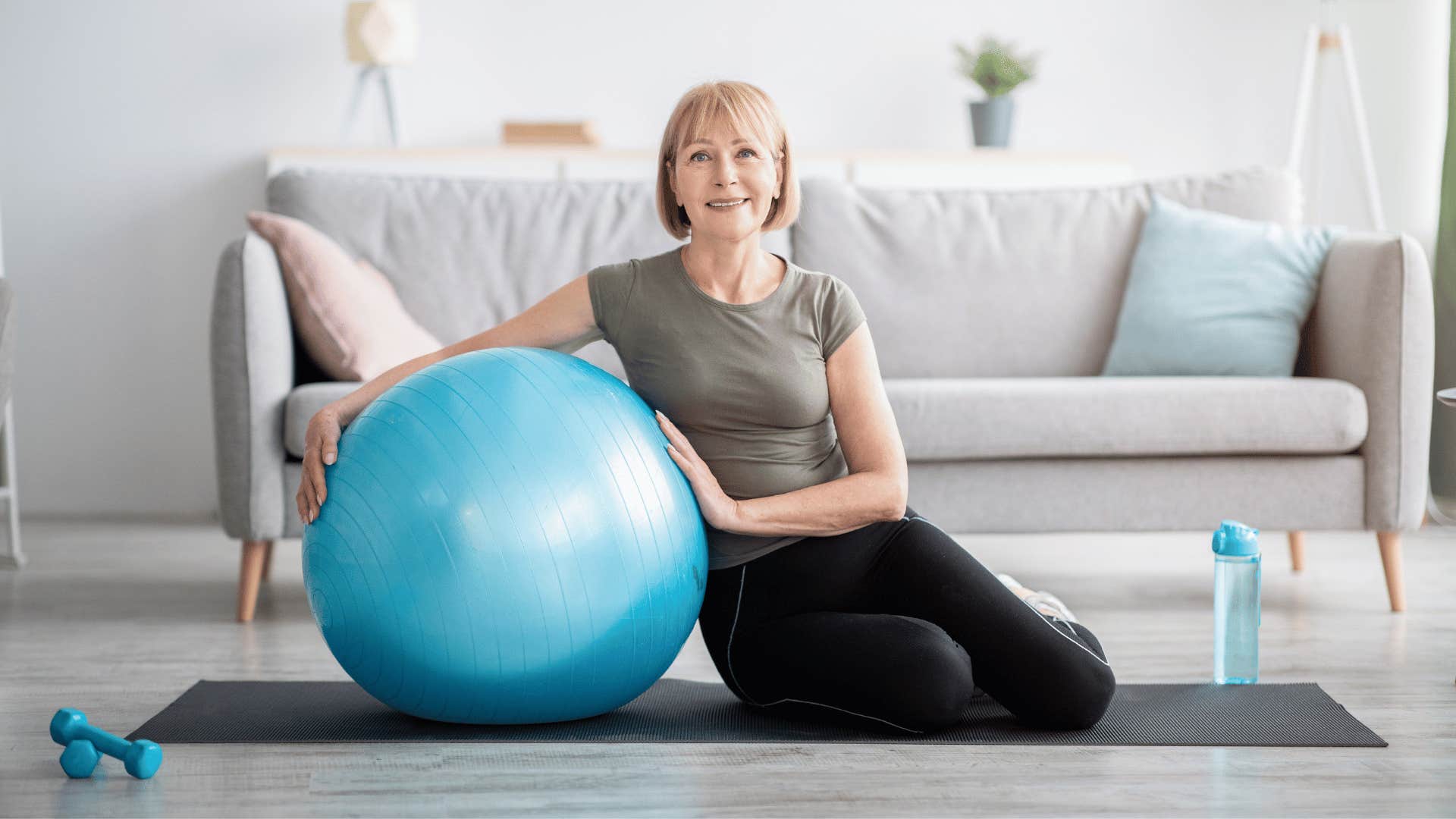 older fit woman with medicine ball exercising