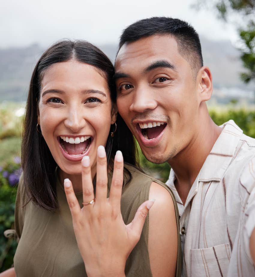 Happy couple show of woman's ring