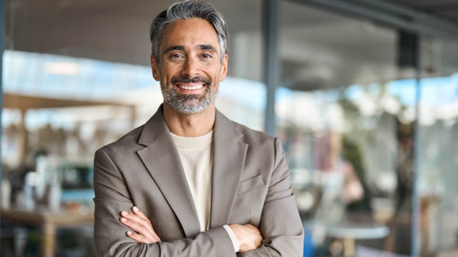confident alpha man smiling with his arms crossed