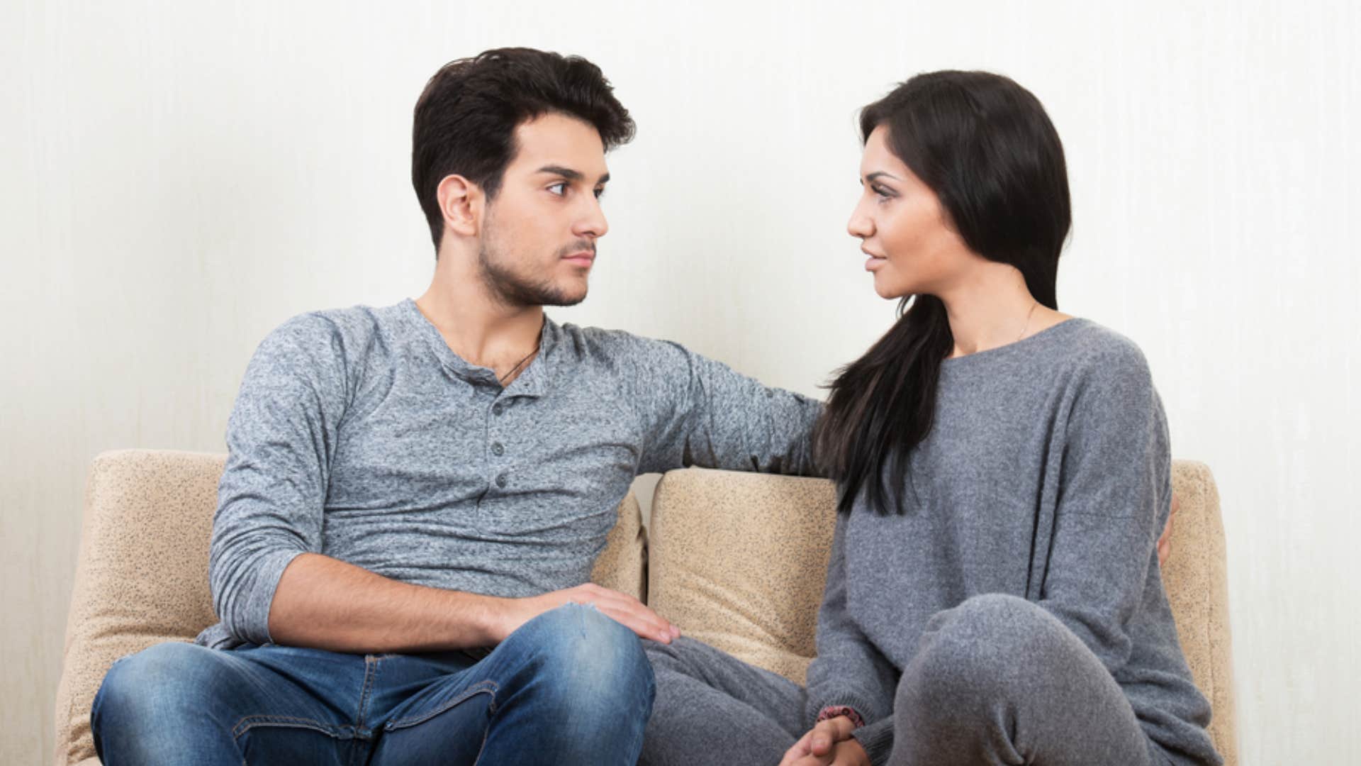man listening to woman speaking