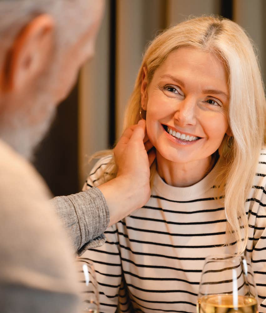 Man shows kindness by softly touching woman's face