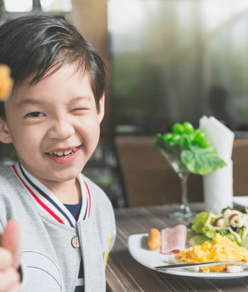 little kid learning how to act at restaurant 