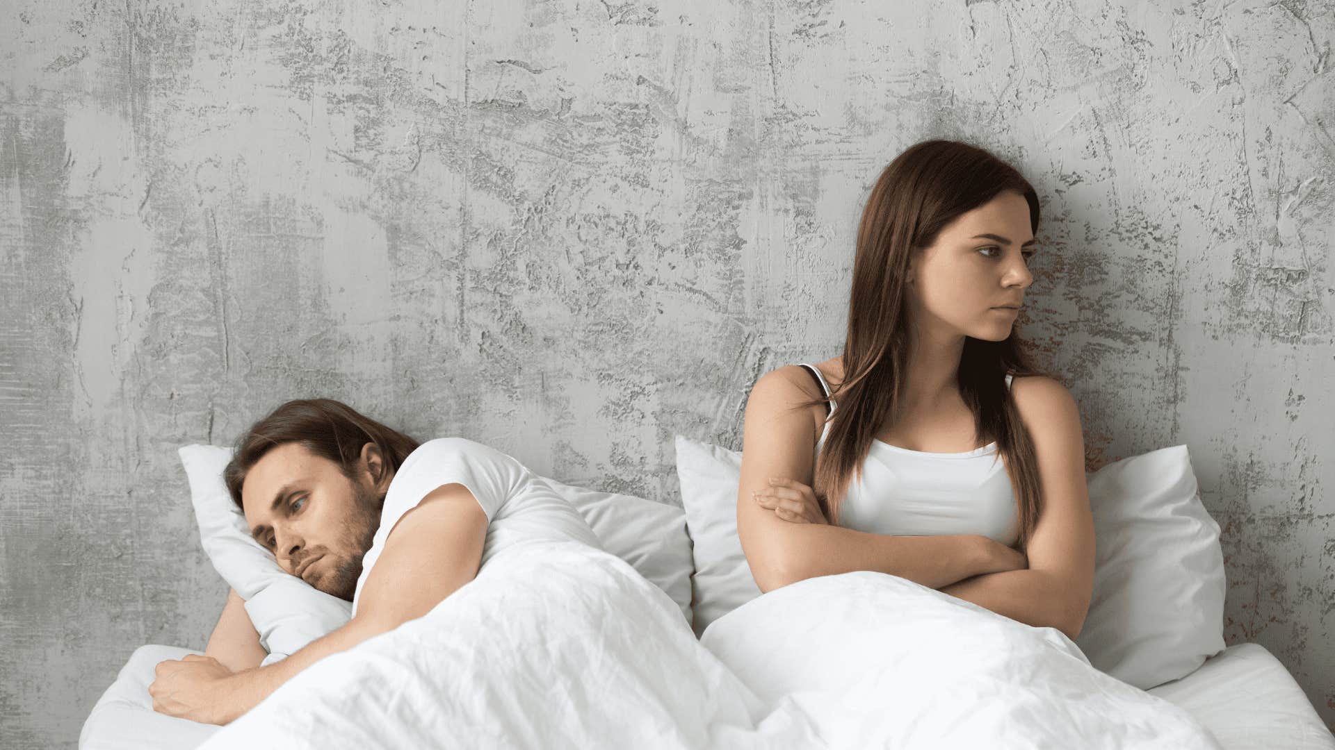 upset couple in bed as marriage tip