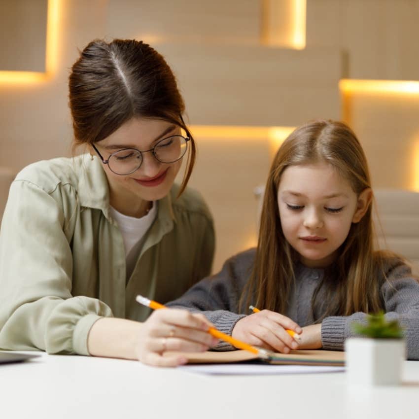 mom helping daughter with schoolwork
