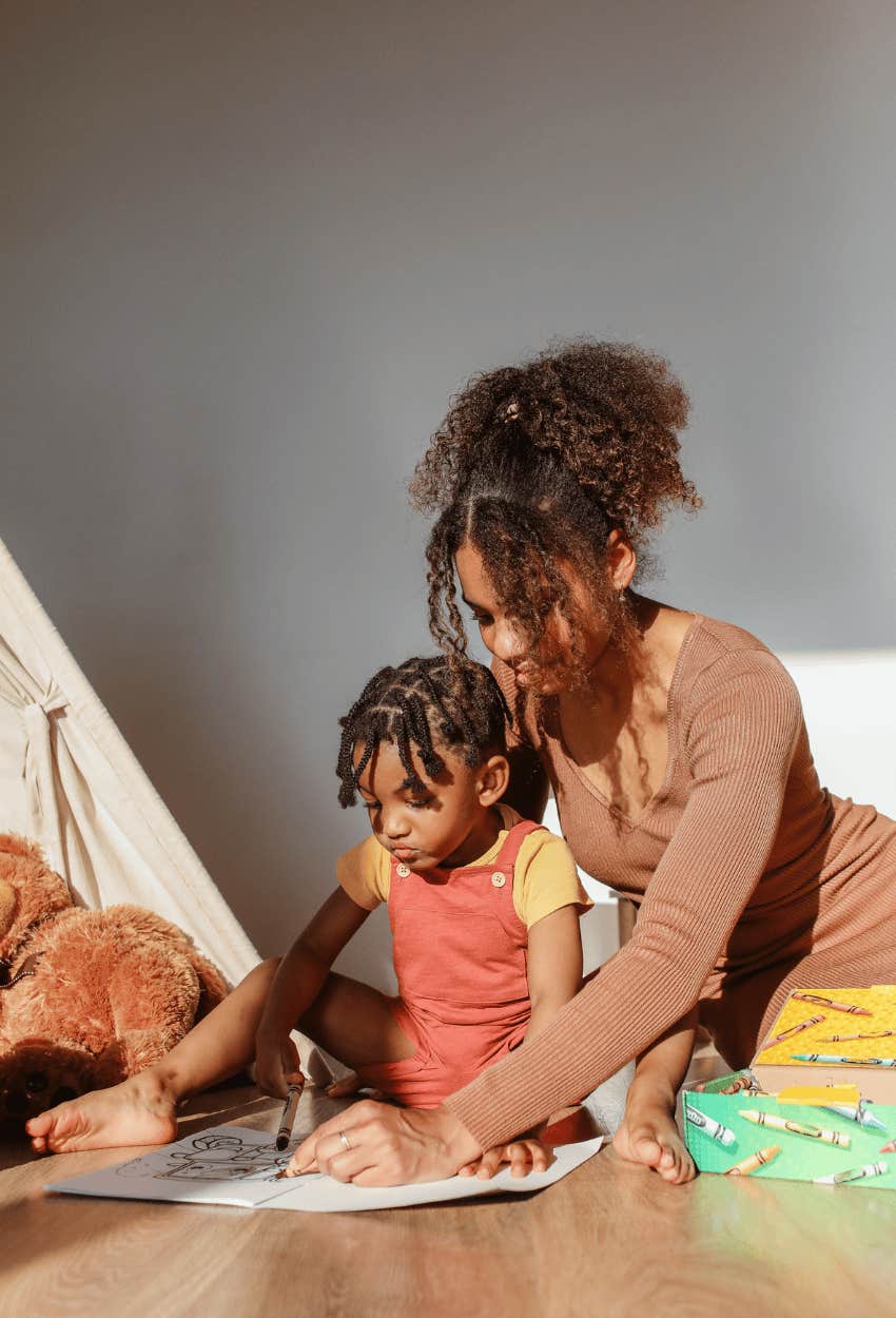 Mom teaching her toddler about consent