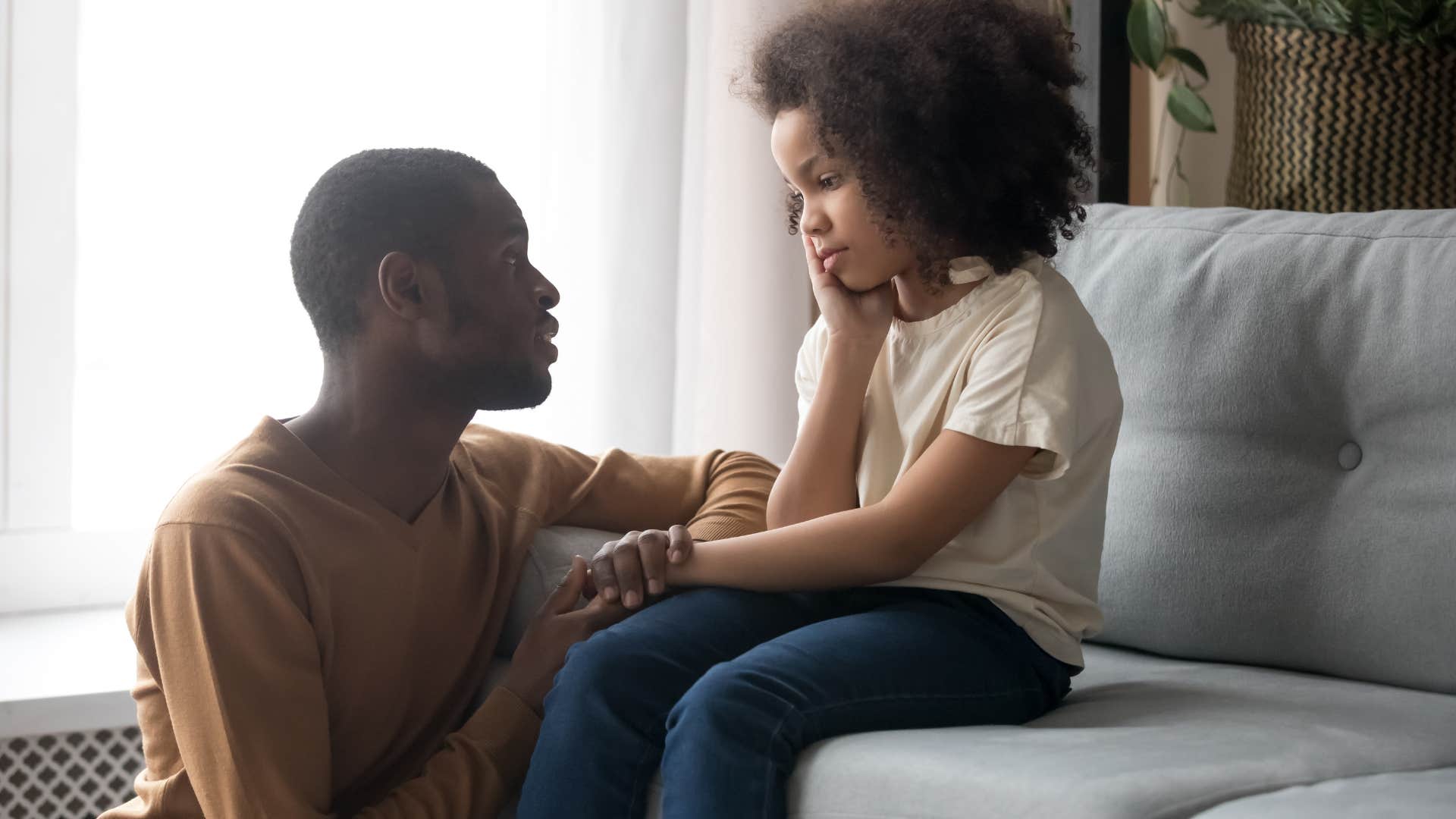Man teaching his daughter to say and accept no