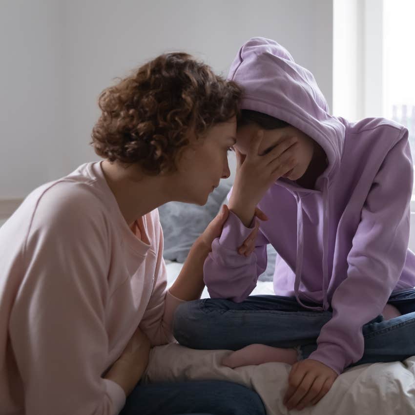 mother consoling daughter while teaching her key concept