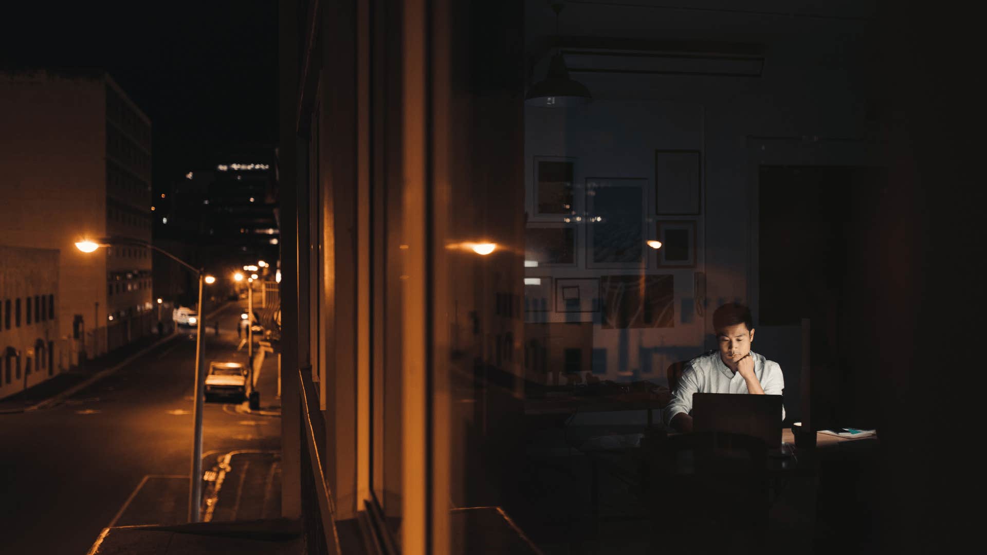 man working late with money mindset of trying again