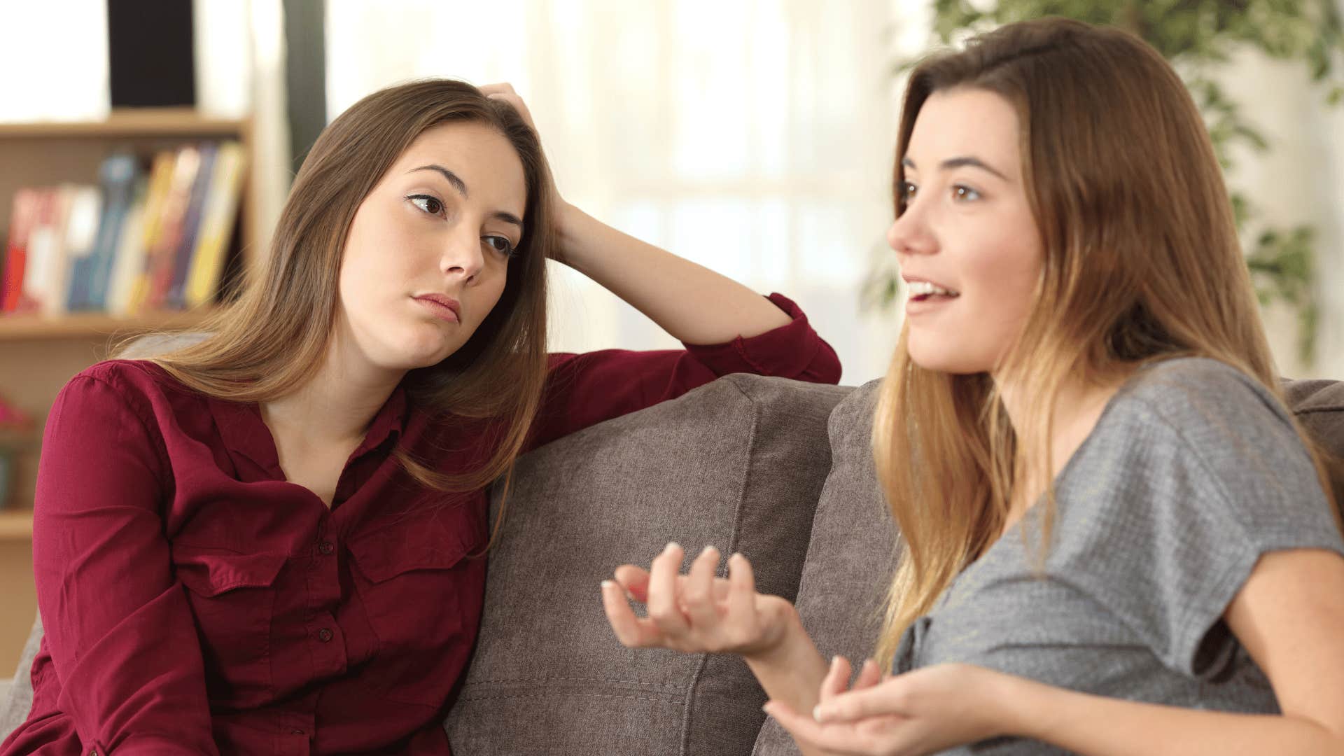 annoyed woman looking at friend who overstepped boundaries