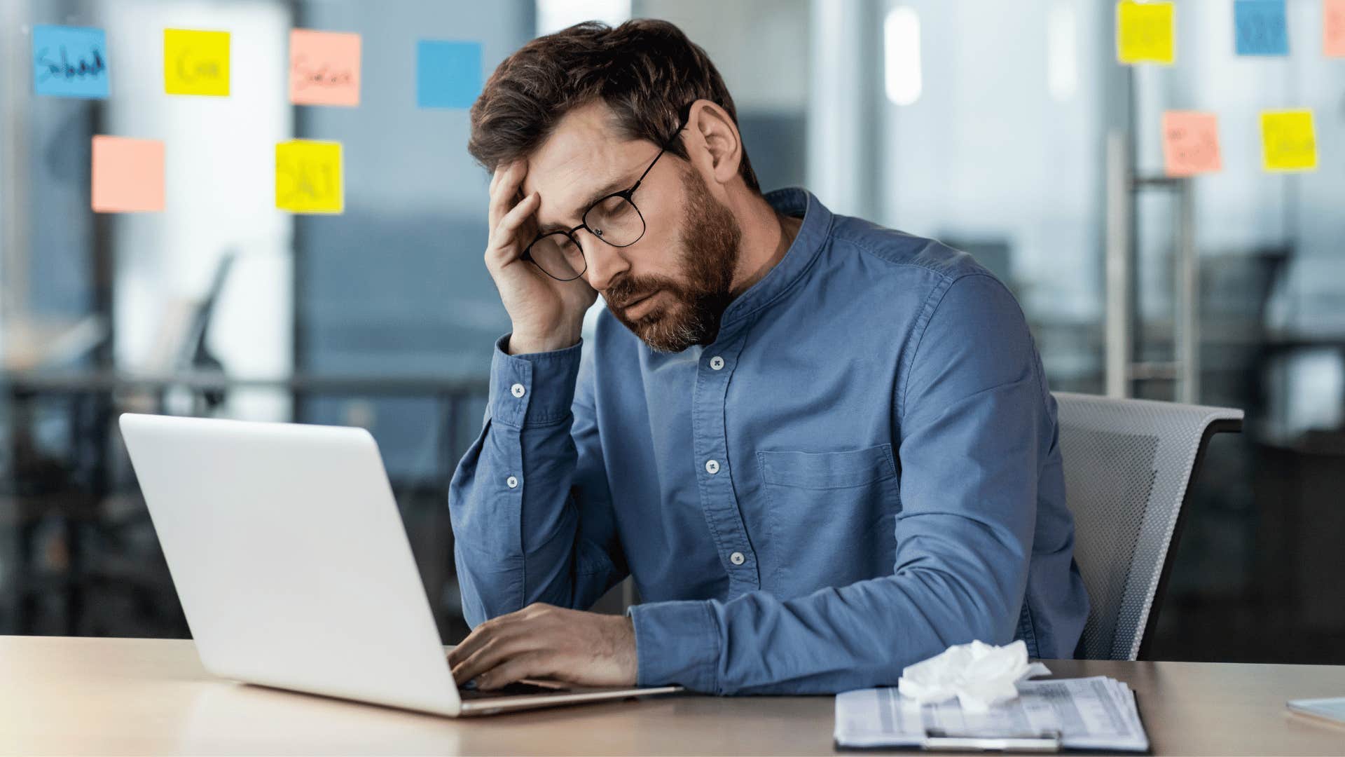 man struggling with a work-life balance looking stressed