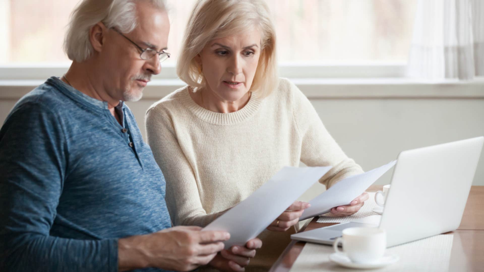 stressed older couple looking at bills