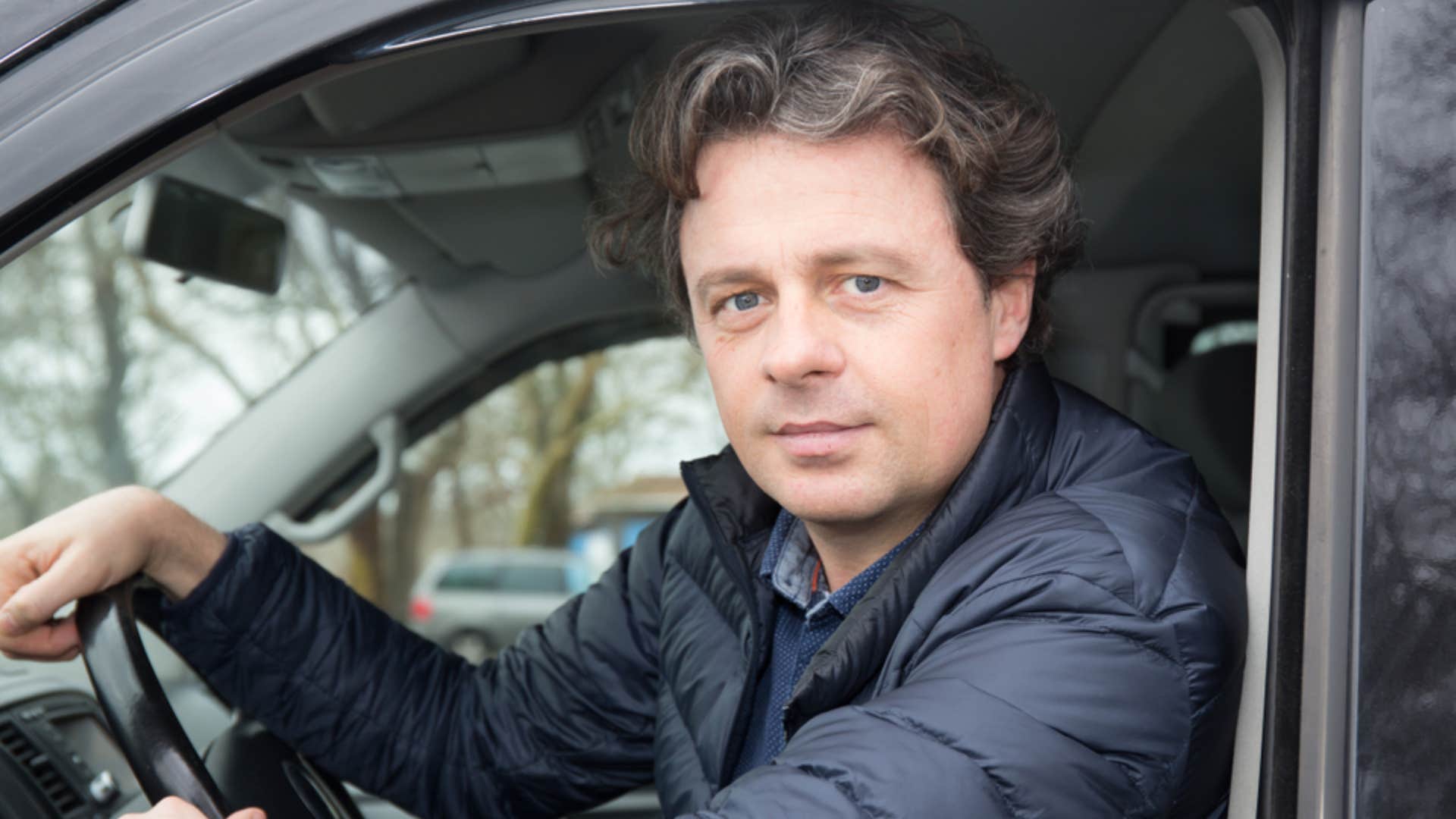 man driving a car