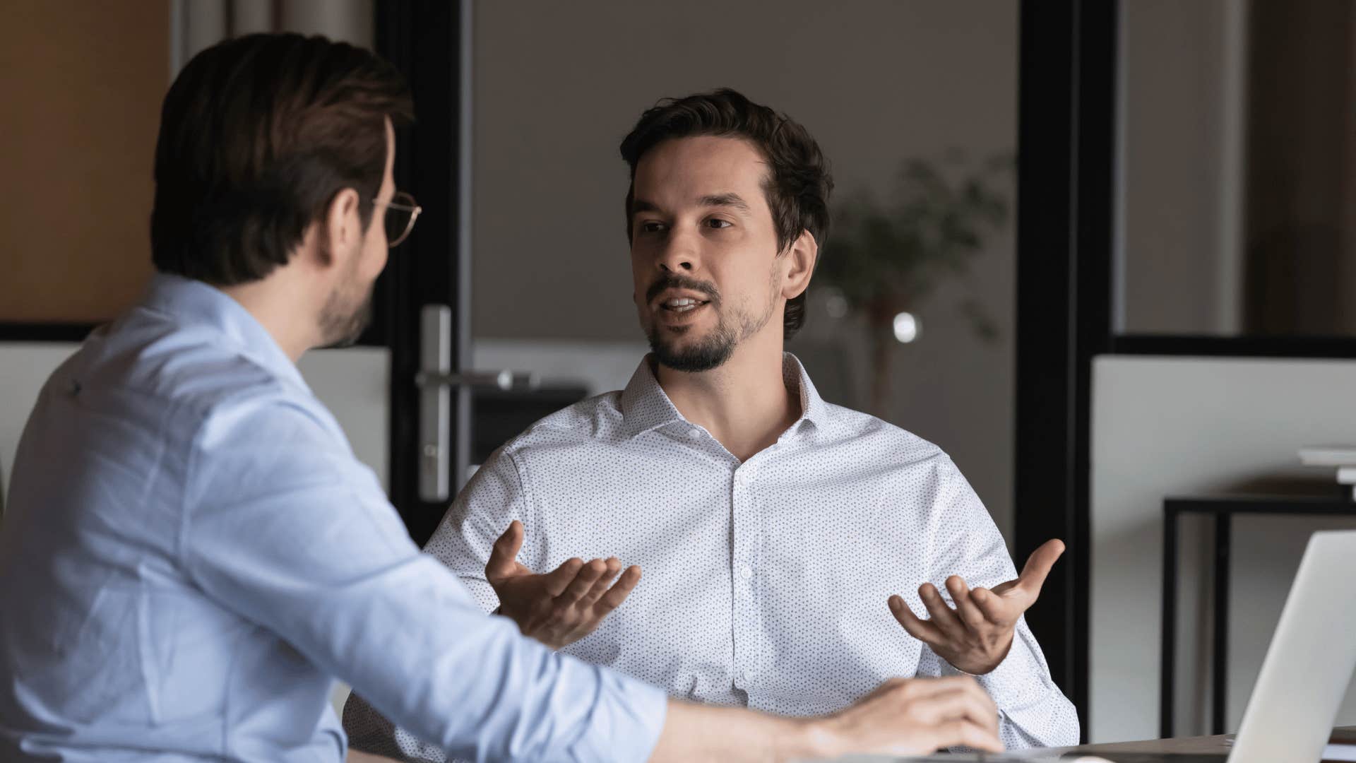 frustrated employee speaking with colleague