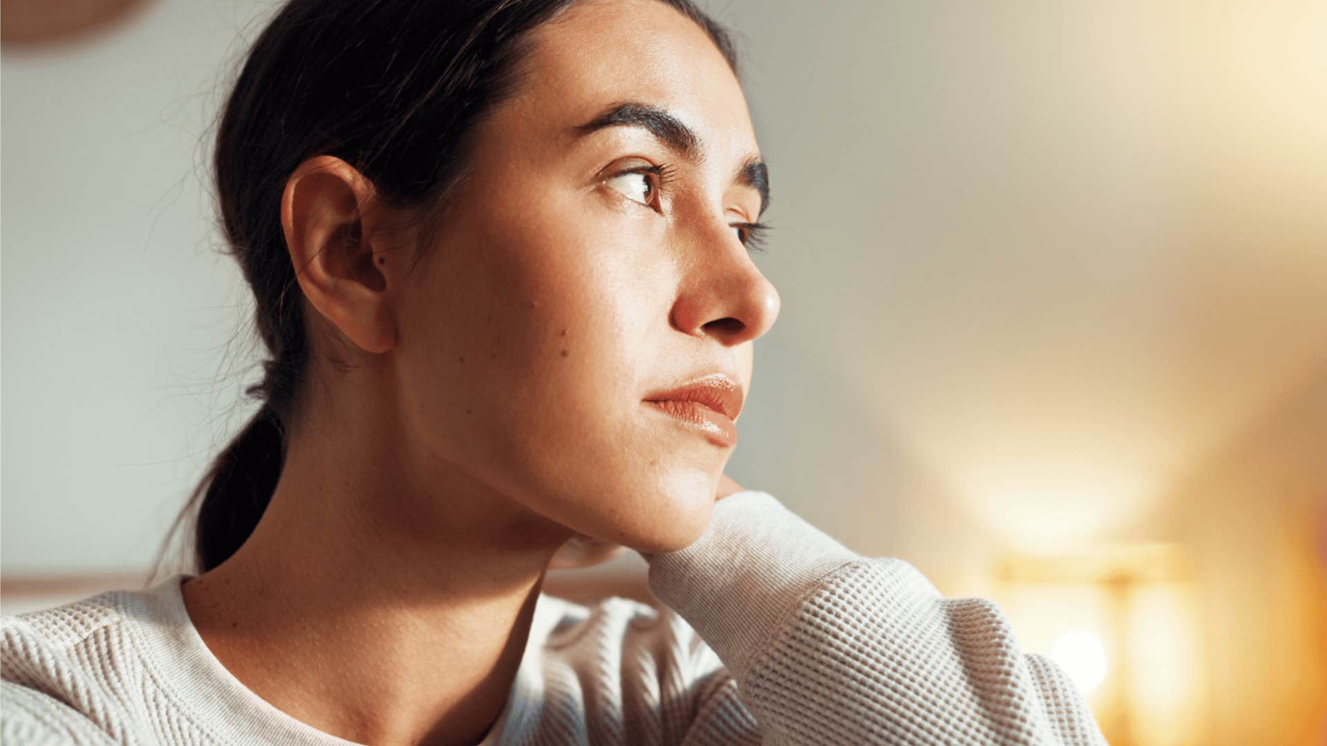 pensive woman staring outside
