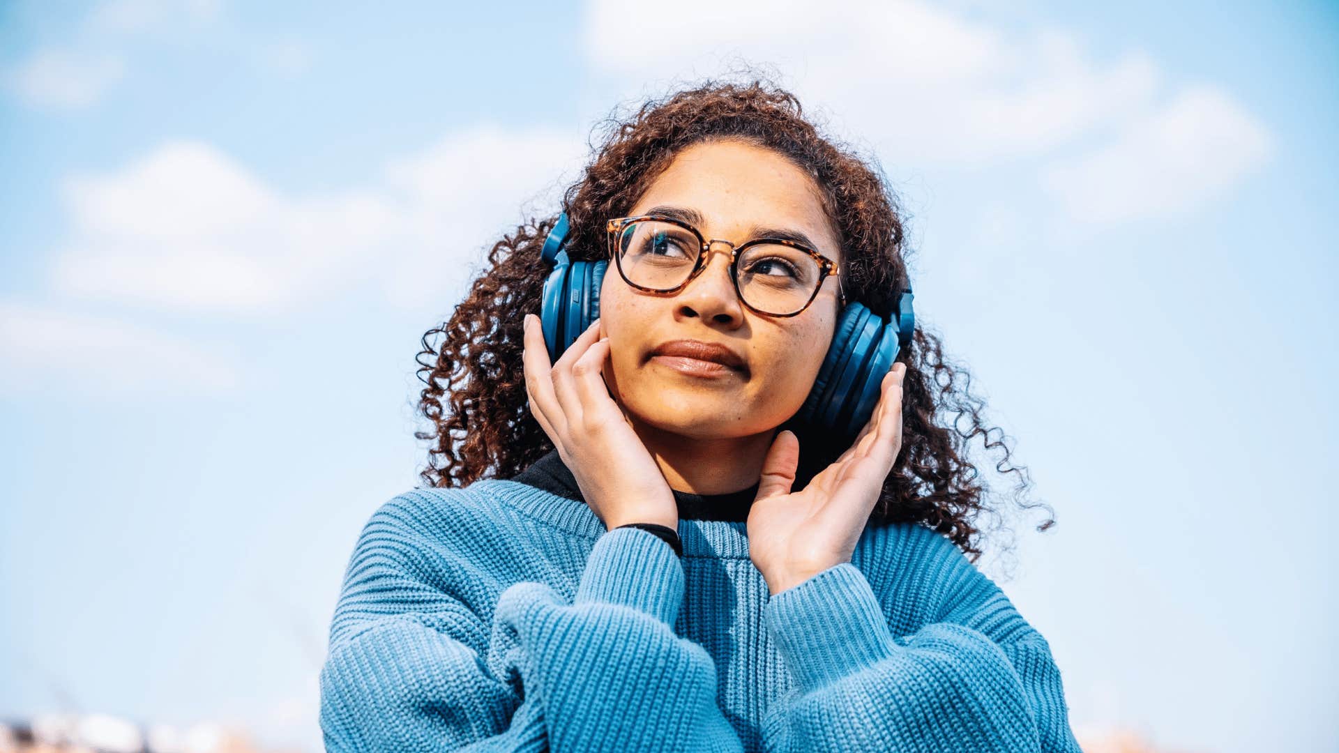 peaceful woman reflecting while listening to music