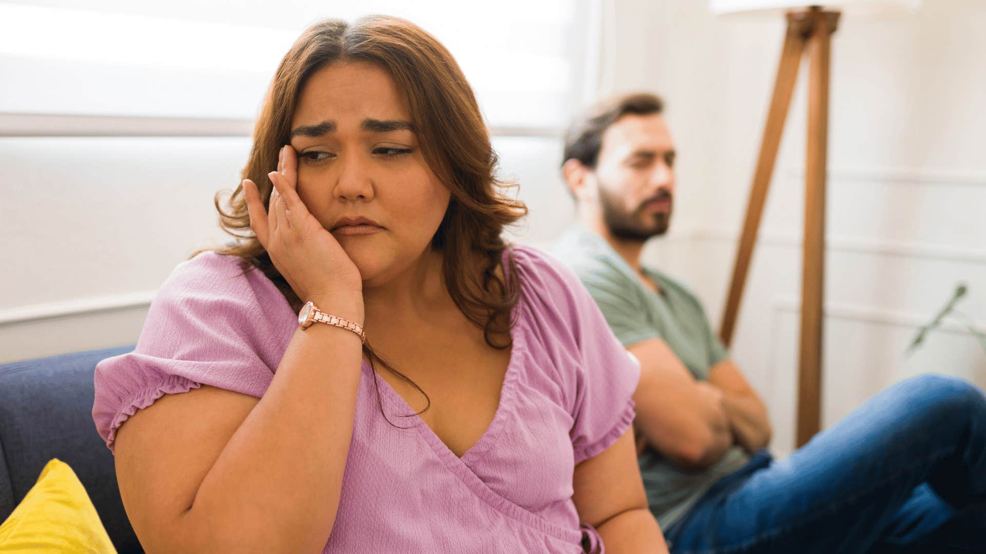 upset woman turned away from narcissistic man