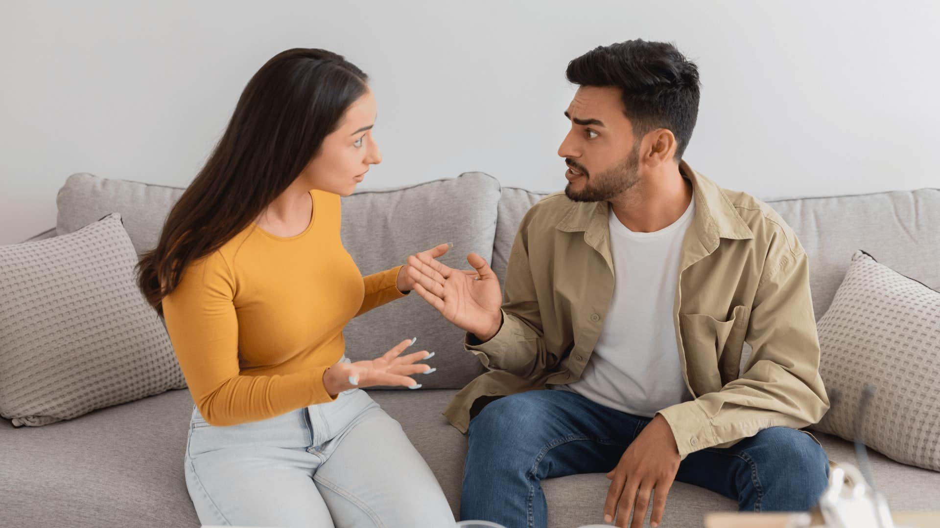 couple arguing sitting on couch
