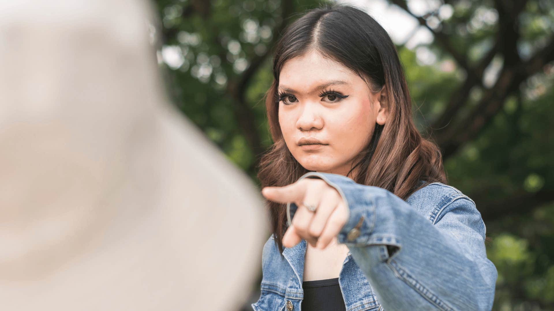 frustrated woman pointing at friend