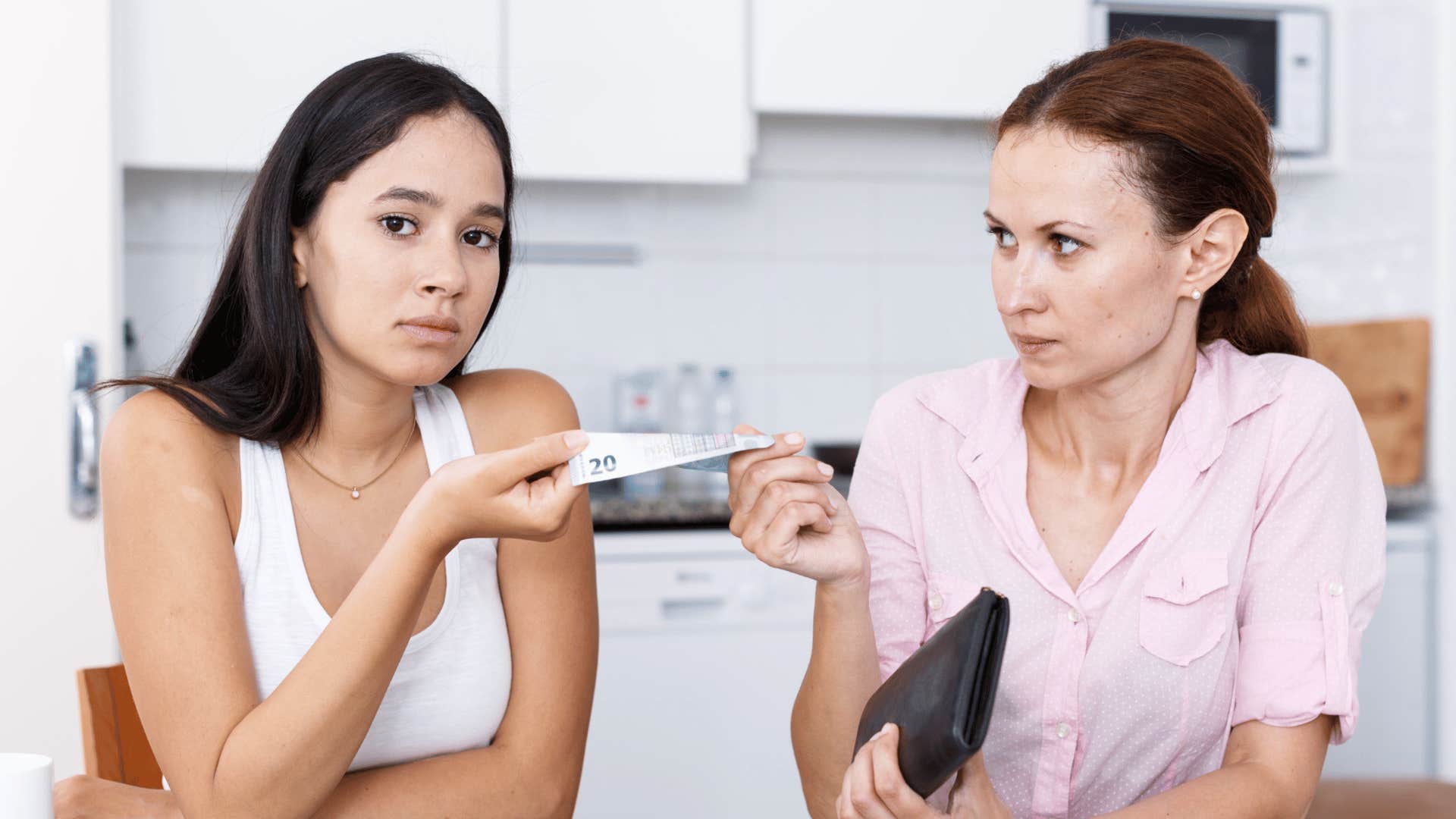 mom giving teen daughter money