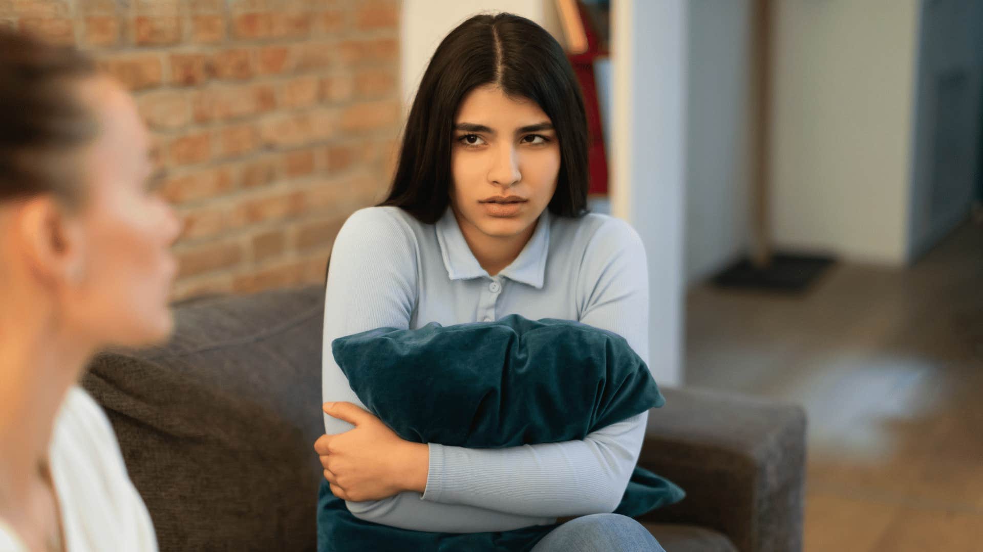 mom lecturing scared teen daughter