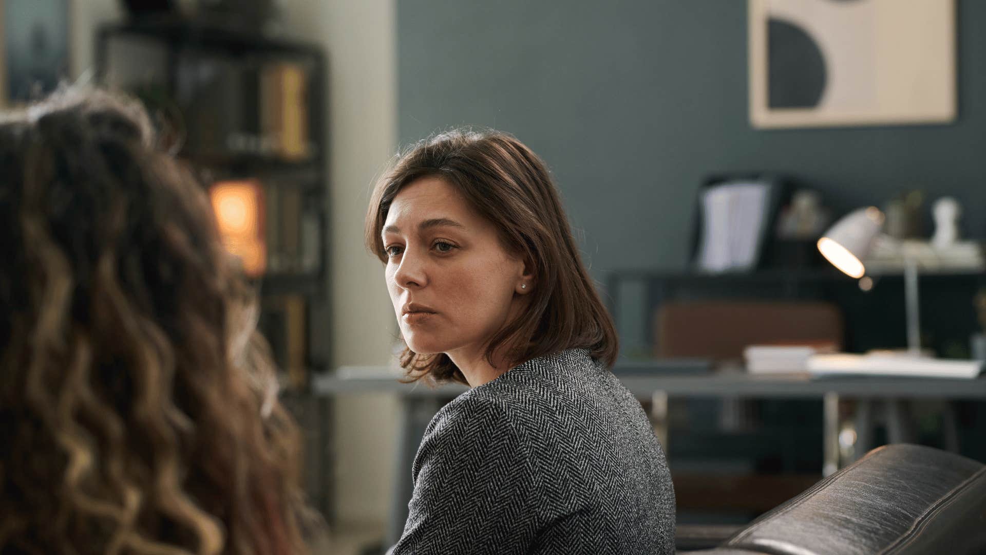 women in living room having serious conversation