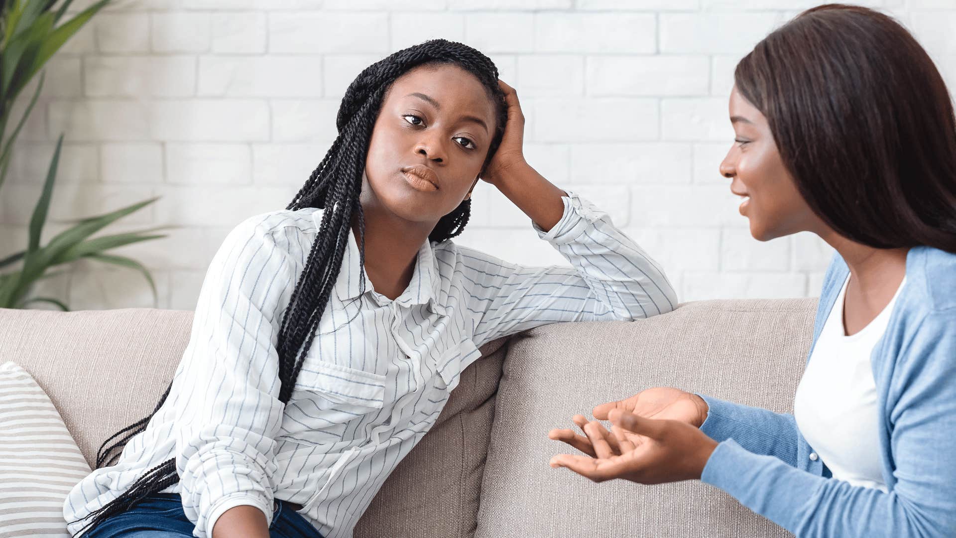 woman uninterested in conversation with defensive friend
