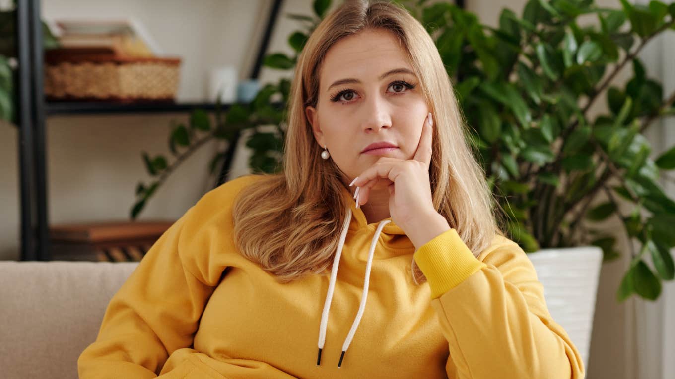 Phrases People Use When They're Trying To Provoke A Negative Reaction Out Of You negative woman with a scowl on her face