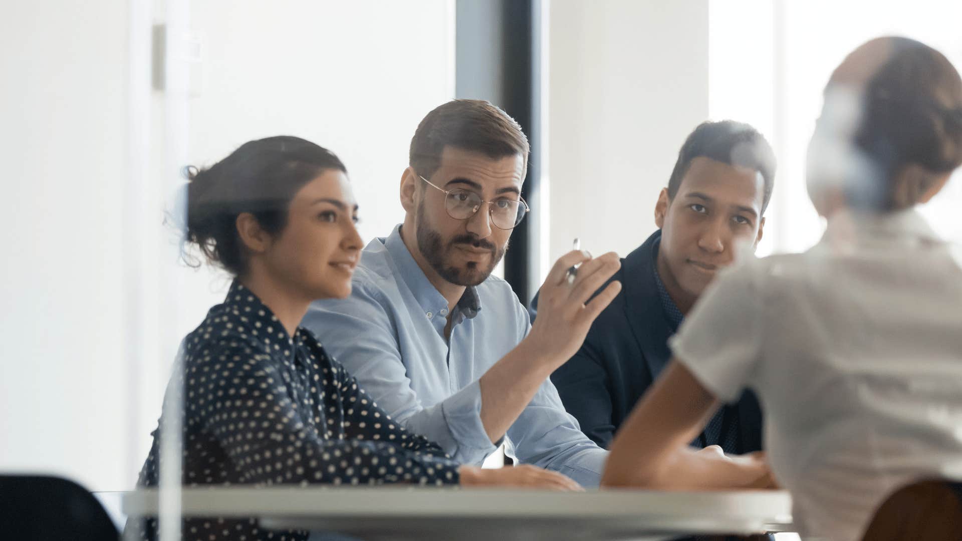 Man explains solution to work team