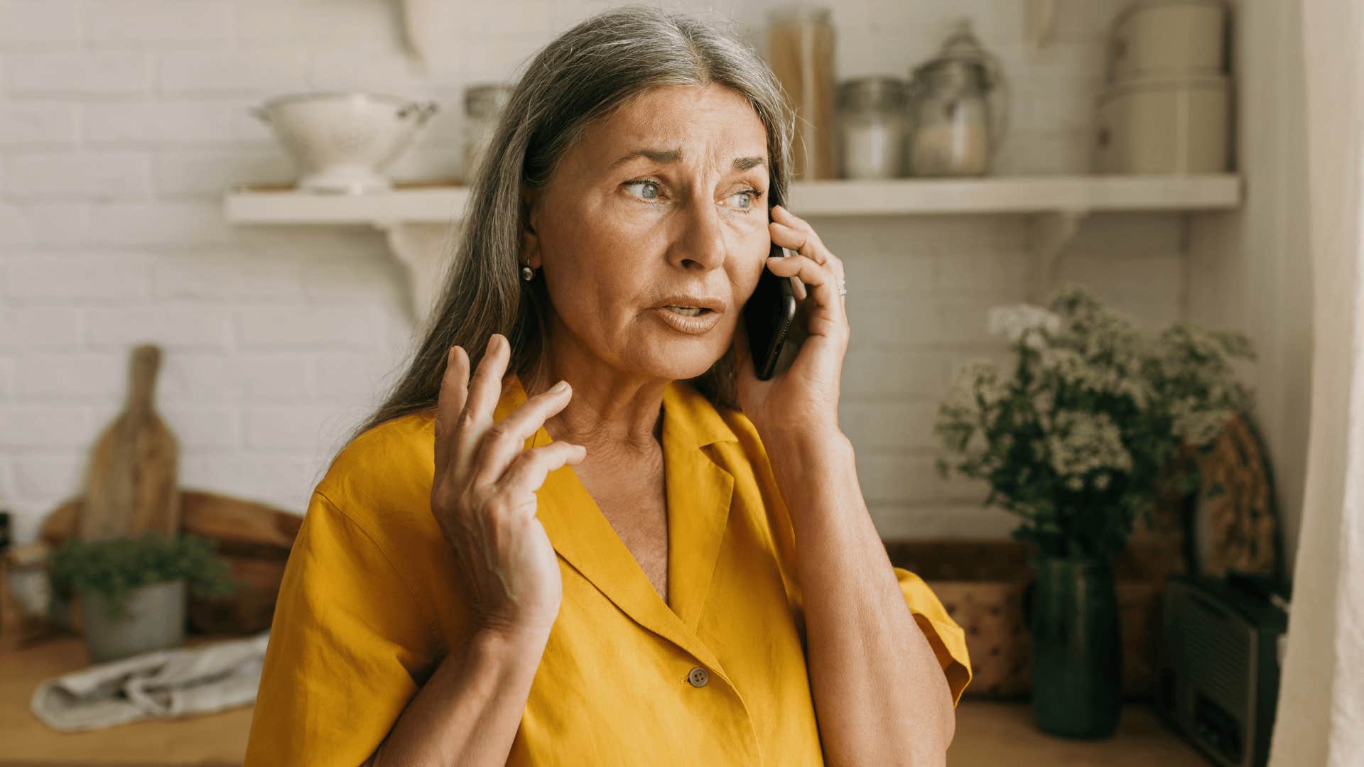 older woman having serious conversation on the phone