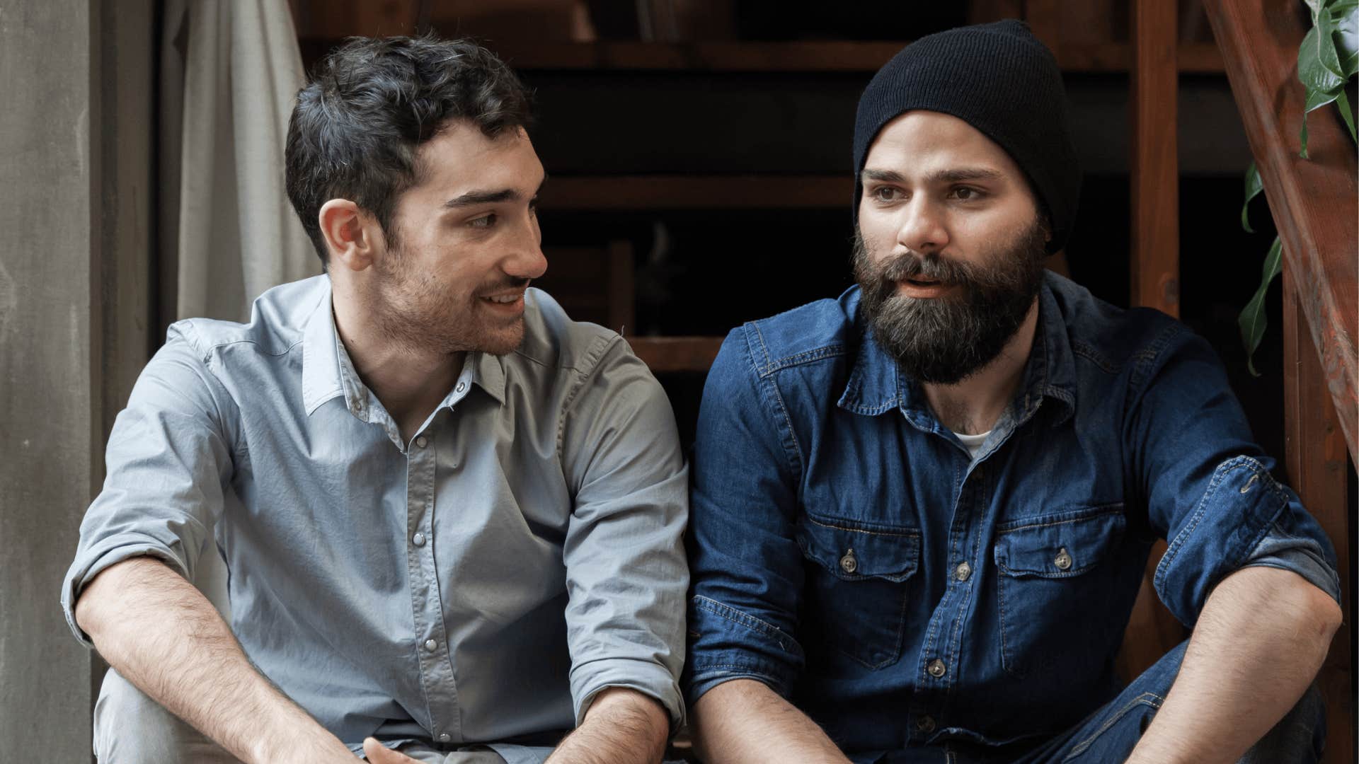 two friends sitting side by side having a conversation