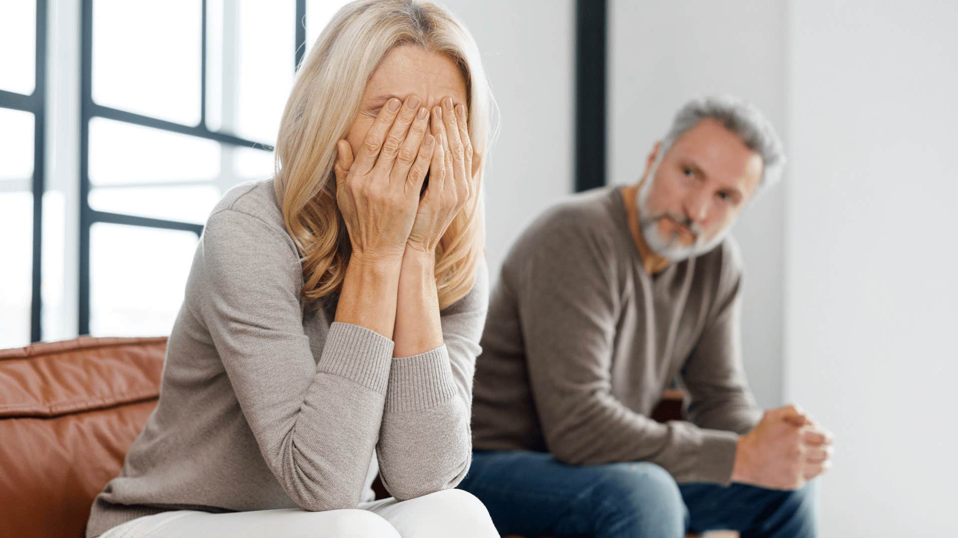 upset woman with hands over her face