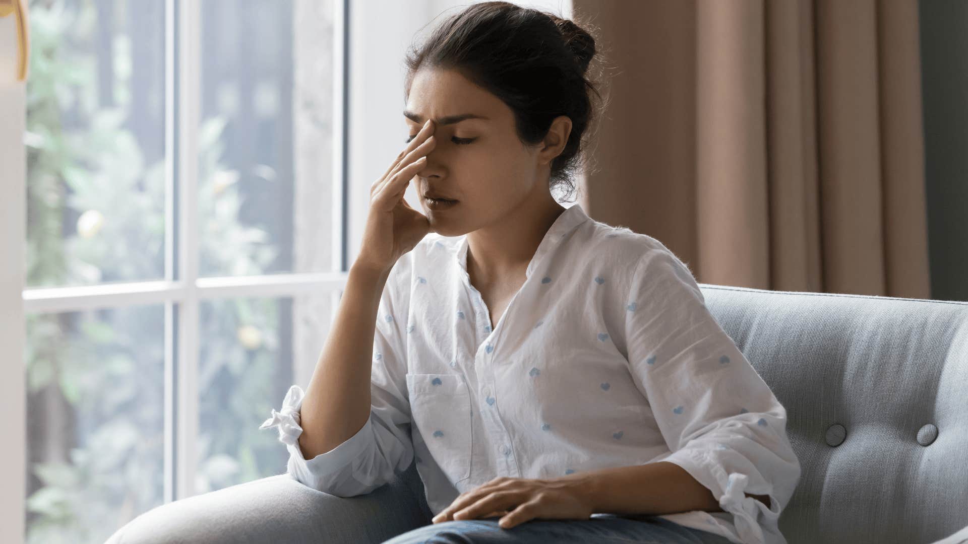 stressed out woman nursing a headache