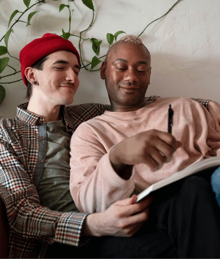 Close couple looks at book together, noticing keeping score