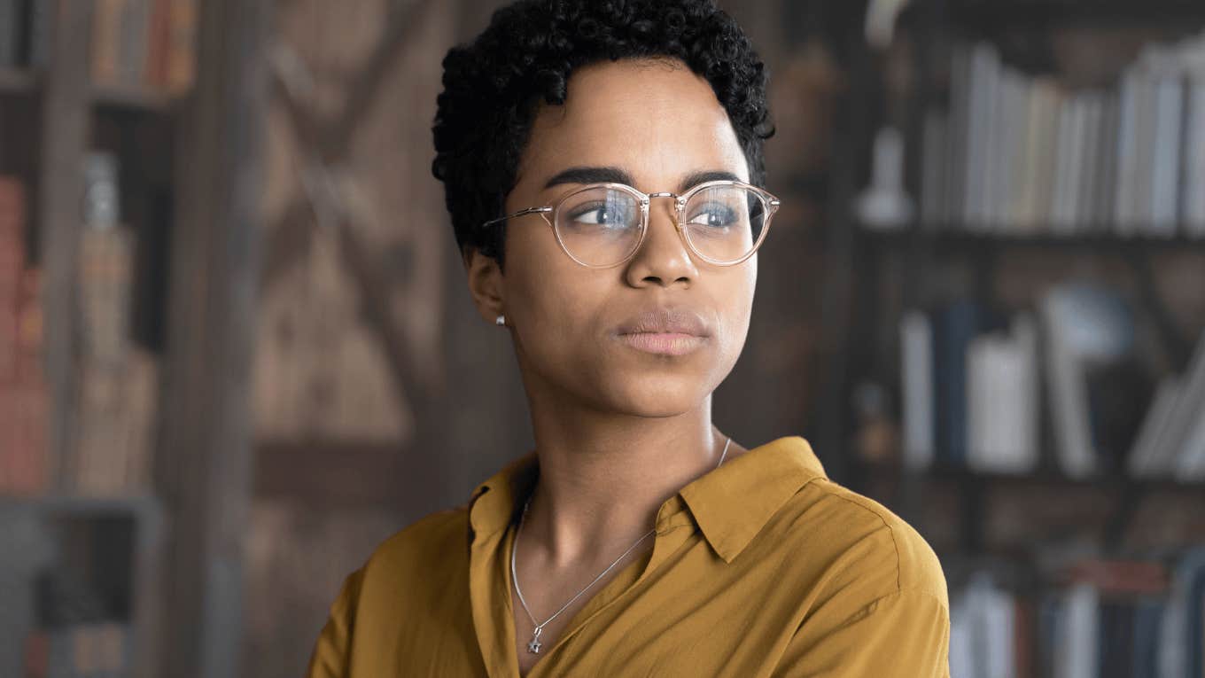 Quiet Ways Gen Z Workers Get Revenge On Their Employers For ‘Unfair’ Treatment At Work Upset Gen Z worker looking away from the camera.
