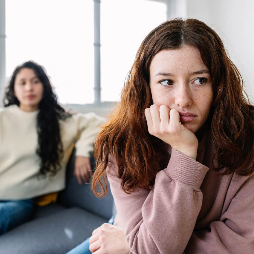 upset woman with friend behind her who's life feels like a struggle
