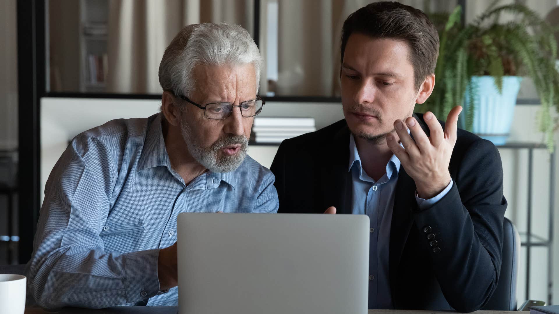 Man arguing with his dad in front of a laptop