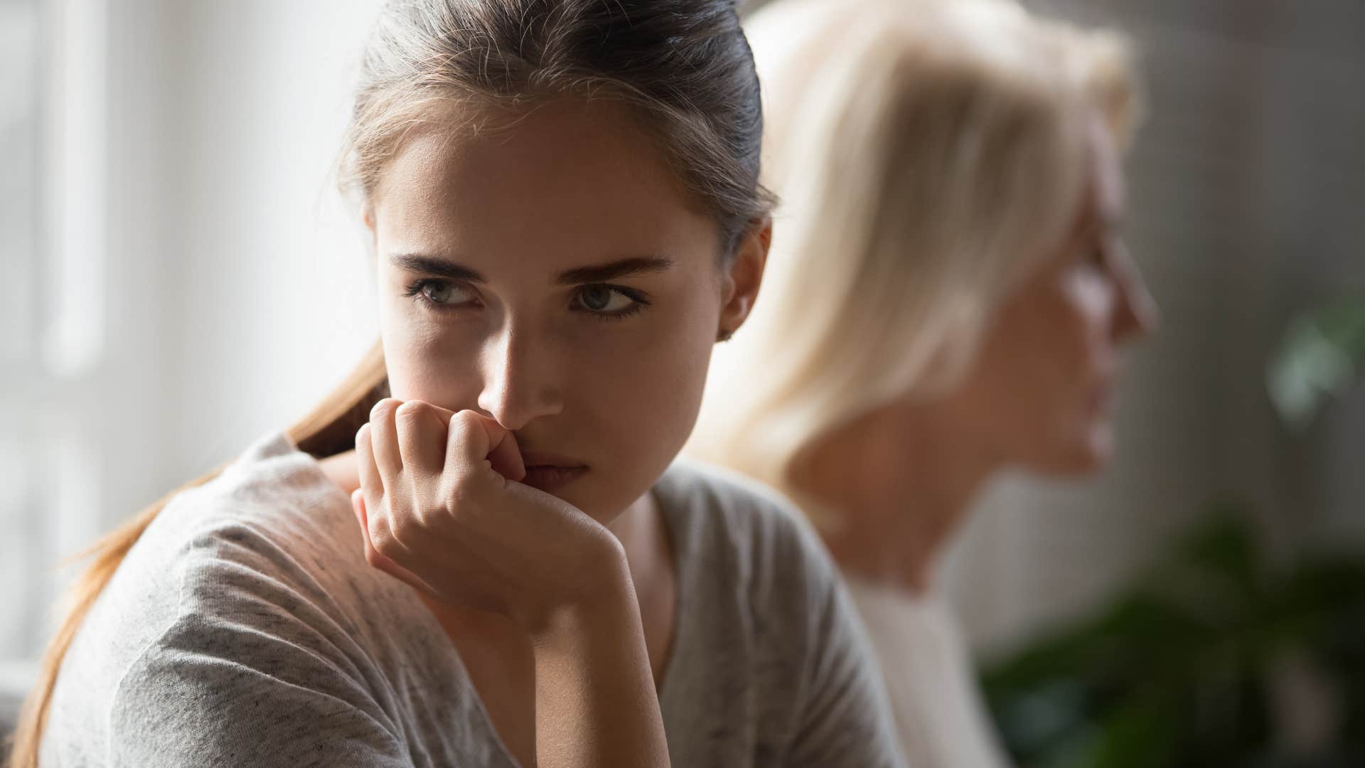 Angry Gen Z woman turned away from her mother
