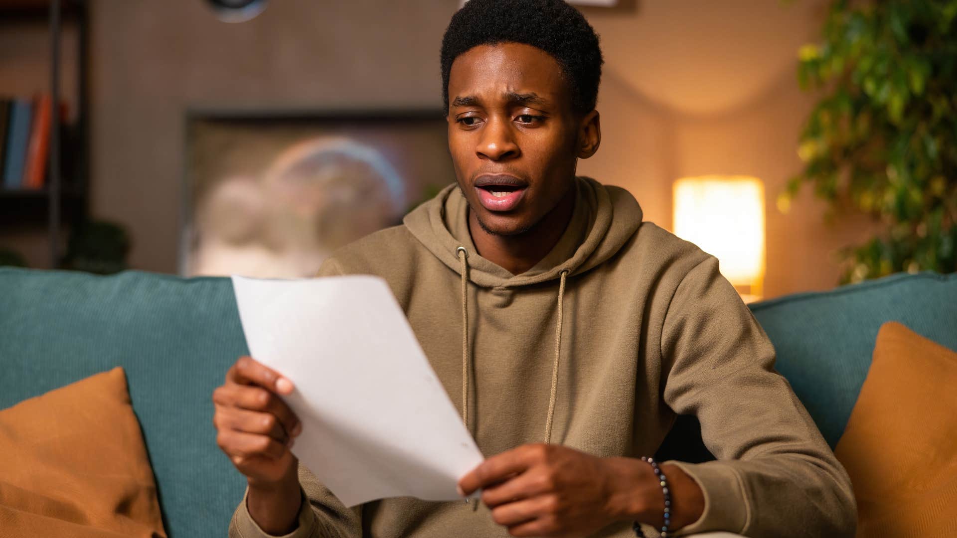 Shocked Gen Z man looking at a piece of paper