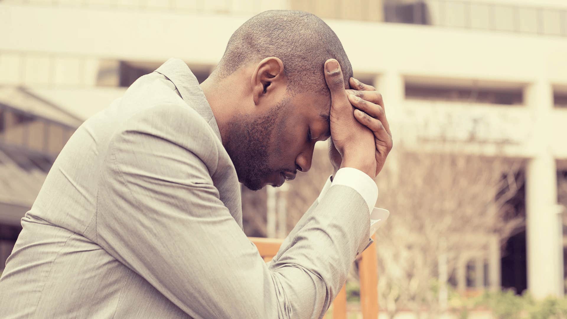 man sitting outside haunted by regrets that destroyed his marriage